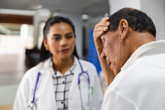 Elderly patient receiving care from a young doctor