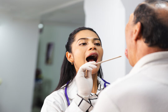 Medical examination of elderly patient by female doctor