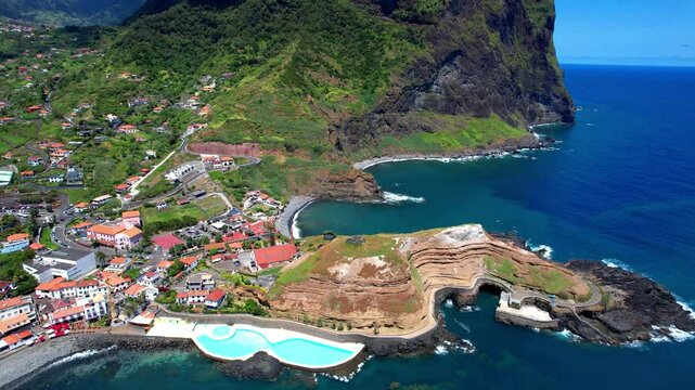 amazing Madeira island nature scenery. aerial 4k hd video of beautiful rocky coast and Porto da Cruz village with natural pools in northern part. Portugal