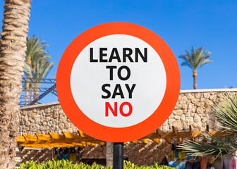 Learn to say no symbol. Concept words phrase Learn to say no on beautiful road sign. Beautiful palm...