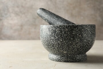 Stone mortar and pestle on light table, closeup