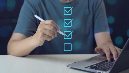 businessman is marking digital checkboxes, representing checklist and task management in a digital...