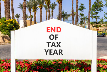 End of tax year symbol. Concept words phrase End of tax year on beautiful big white road sign....