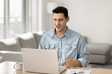 Shocked with excitement. Overjoyed gen z male freelancer scream wow super looking on notebook screen getting great job offer perfect new work opportunity financial reward feel like winning lucky prize