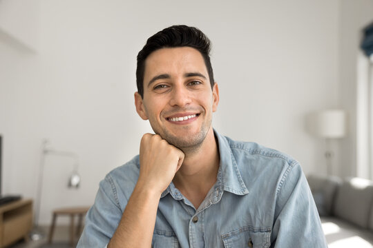 Casual professional networking. Webcam view portrait smiling confident young man remote student freelancer vlogger making video call taking part in virtual conference streaming live from home office
