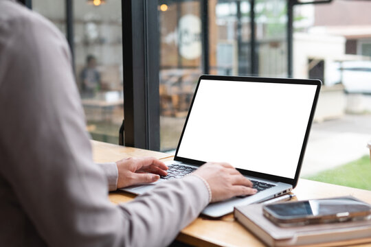 Young woman working on laptop with white screen