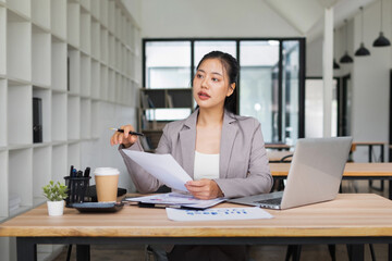 Businesswoman picks up documents to check information