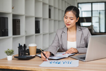 Businesswoman picks up documents to check information