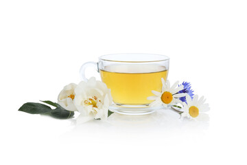 Aromatic herbal tea in glass cup and flowers isolated on white