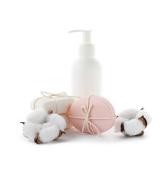 Soap bars, bottle of skincare product and cotton flowers isolated on white
