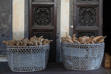 Baskets with raw sweet potatoes in market