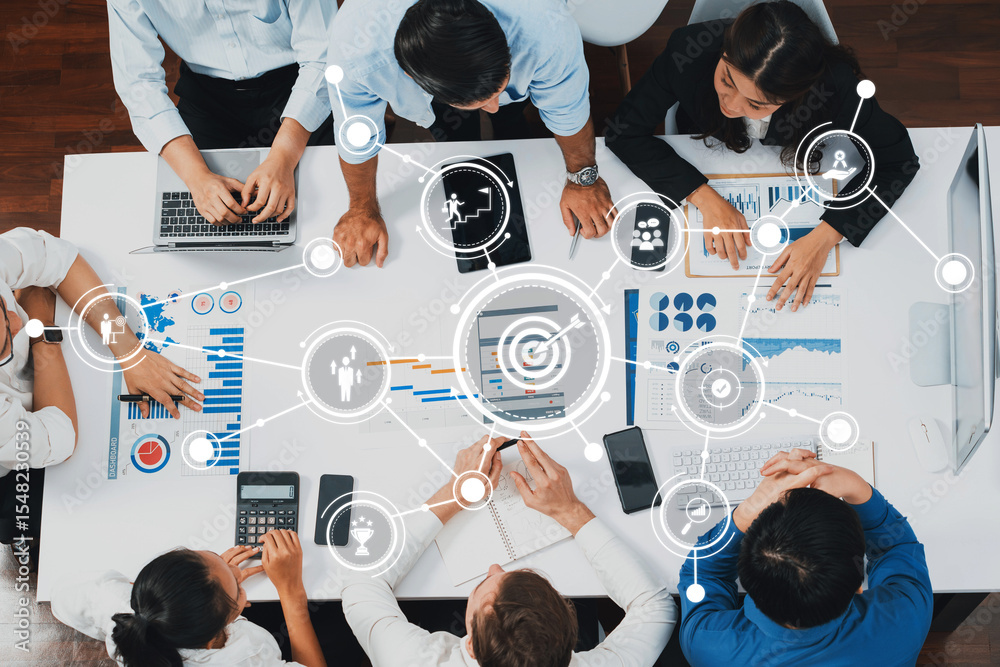 Poster Overhead view of business professionals engaged in a collaborative meeting with charts and laptops, demonstrating data analysis and technological connectivity for effective decision-making. Amity