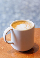 Warm cappuccino in a cup with latte art on top
