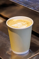 Warm cappuccino in a cup with latte art on top