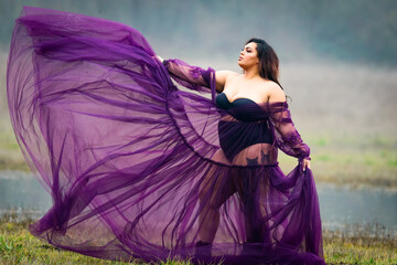 Flowing dress in the wind in a meadow