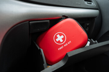 Inside the glove box of the car, you will find a compact red first aid kit that is absolutely...