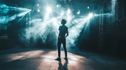 Fototapeta premium Dramatic stage silhouette of dancer in spotlight with fog and backlight performance show entertainment lights