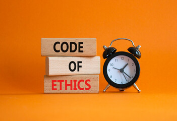 Code of ethics symbol. Concept words Code of ethics on wooden blocks with alarm clock. Beautiful...
