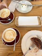 Coffee and desserts on wooden table in cozy café