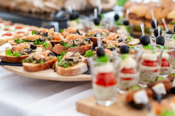 Gourmet Appetizers on a Wooden Plate at an Elegant Buffet Wedding Event