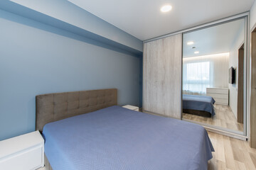 Modern Home Minimalist Bedroom with Blue Bed and Wall-Mounted Television