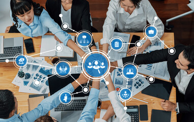 A dynamic business meeting showcasing collaboration and data visualization among diverse...