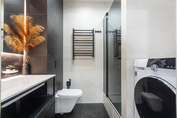 This stylish bathroom features a contemporary design with a shower, elegant decorations, and...