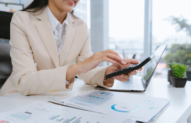 Businesswoman Calculating Financial Data at Desk