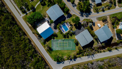 Homes with tennis court and swimming pool between them in south west florida 
