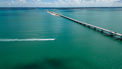 Drone view of Speed boat in San Carlos bay near Sanibel Island Causeway. Turquoise water  