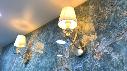 Elegant Wall Sconce Lamp with White Lampshade and Crystal Drop on Luxury Green Marble Wall in Modern Interior