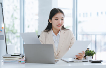 Young Asian Woman Working with Documents at Desk
