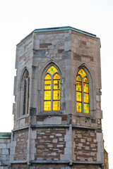 Medieval church tower ruin with colorful stained glass windows