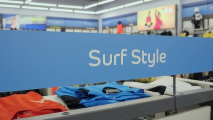 Sports department with the inscription "surf style". Sportswear for surfing. Special sportswear for water sports.