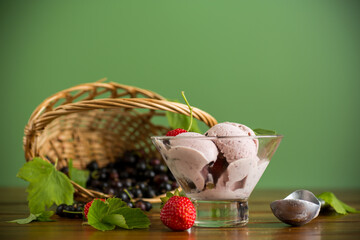 Refreshing berry ice cream on green background