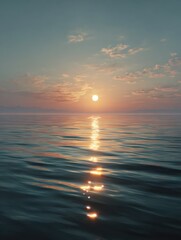 Obraz premium A serene sea at sunset, with the sun's reflection on calm waters, creating an atmosphere of tranquility and serenity.