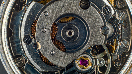 Close-up of the mechanism of an old wristwatch, symbolizing time and its transience, dirty metal and dust