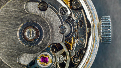 Close-up of the mechanism of an old wristwatch, symbolizing time and its transience, dirty metal...