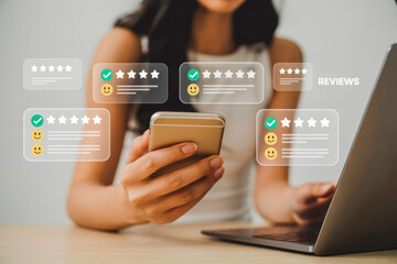 A woman checks reviews on her smartphone while using a laptop, highlighted by overlaying graphics of star ratings and smiley faces, indicating user feedback and satisfaction in an online context.