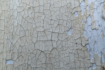 Close-up of weathered peeling paint on old wall surface
