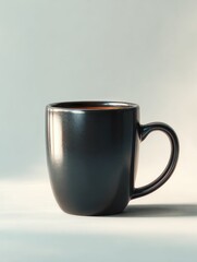 A black coffee mug sits on a white table with soft lighting.