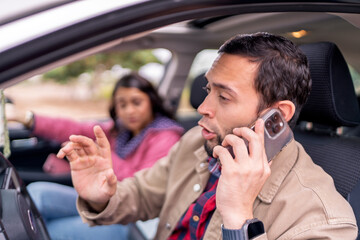 Couple having car trouble calling for roadside assistance