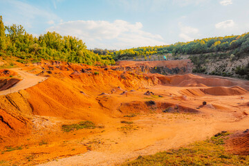 Gant, Hungary, view of the terraces of an old bauxite mine and bauxite formation with red and orange surface. Gánt Bauxitbánya.