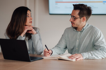 Business colleagues discussing strategy during meeting in modern office