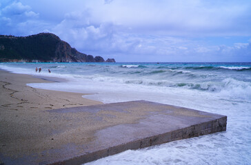 Serene Beach Shoreline With Ocean Waves and Distant Coastal Landscape