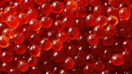 Overhead shot of vivid red caviar forming a rich, textured background