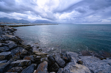 Rocky Shoreline with Overcast Skies and Calm Ocean Waters