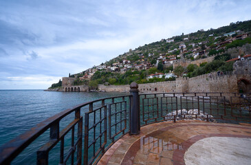 Naklejka premium Scenic Coastal Town with Old Stone Walls and Calm Blue Sea
