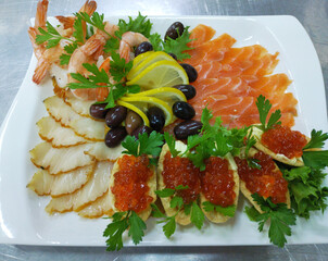 fish platter with red caviar and shrimps. salmon, butterfish, shrimp tails and tartlets with red...