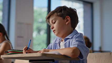 Group classmates studying class room closeup. Elementary school children writing